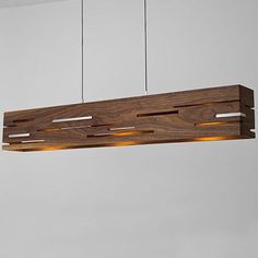 a wooden light fixture hanging from a ceiling