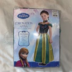 the frozen princess coronation anana costume is in its package on top of a bed