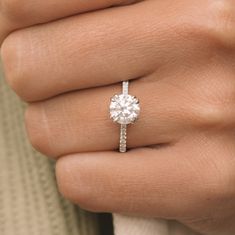 a woman's hand with a diamond ring on it