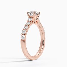 a rose gold engagement ring with three stones on the side