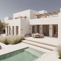 a house with a pool in front of it and some chairs around the outside area