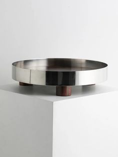 a large metal plate sitting on top of a white counter next to a black and brown object