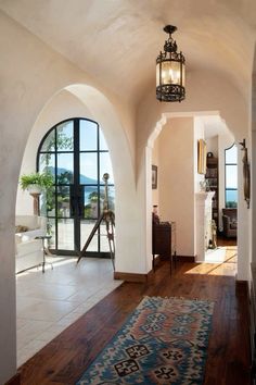 an archway leads to the living room and dining area, which overlooks the ocean