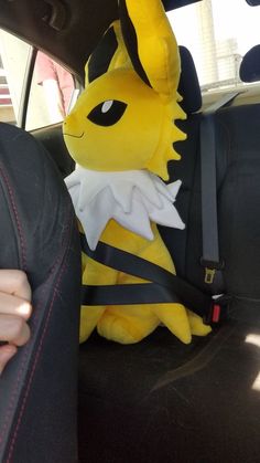 a stuffed animal sitting in the back seat of a car