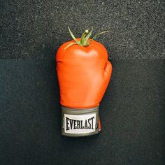 a tomato shaped like a boxing glove with the word everlast on it's side