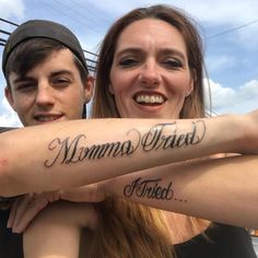 two people with tattoos on their arms are posing for the camera while one has his arm wrapped around the other