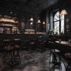 the interior of a restaurant with black walls and wooden bar stools, dark wood tables and chairs