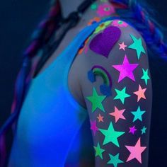 a woman with her arm covered in neon stars