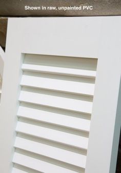 a close up of a window with white shutters