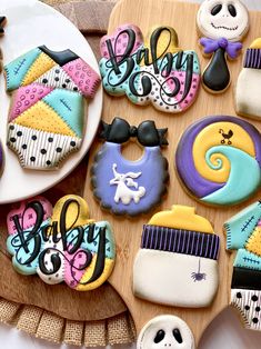 decorated cookies are arranged on a wooden tray