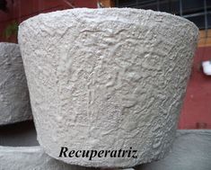 two white vases sitting next to each other on top of a metal table with the words recuperatiz written below them