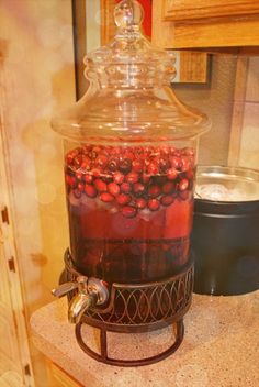 a glass jar filled with liquid sitting on top of a counter next to a stove