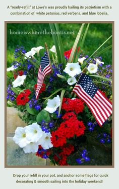 an arrangement of flowers with american flags in the center and red, white, and blue flowers