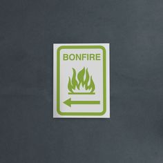 a green bonfire sign on a gray wall