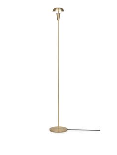 a gold floor lamp with a black cord on the bottom and a white light behind it