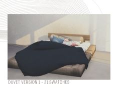 an image of a bed that is made up with black sheets and blankets on it