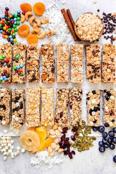 an assortment of granola bars with nuts, seeds, and fruit on a white surface