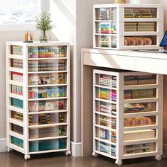 two white shelving units with various items on them in front of a computer desk