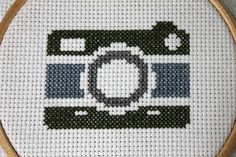 a cross stitched picture of a camera