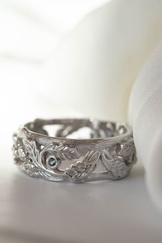 a close up of a wedding ring on a white cloth