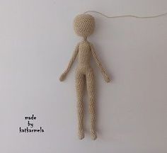 a knitted doll is hanging on the wall next to a cord that has been plugged in