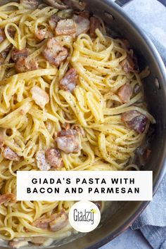 a pan filled with pasta and meats on top of a table next to a towel