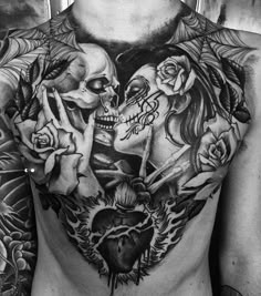 a man's chest with two skulls and roses on it