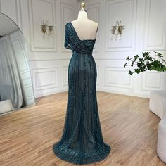 Radiating elegance and allure, this green mermaid evening gown is perfect for upscale wedding affairs in 2024. The mermaid silhouette gracefully accentuates curves, offering a flattering and glamorous fit, while the one-shoulder design adds a touch of sophistication. Featuring a high split, the gown exudes modernity and adds a hint of drama to your look, allowing for graceful movement. Adorned with intricate beadwork, it sparkles with every step, ensuring all eyes are on you as you celebrate in