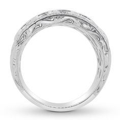 a wedding ring with intricate engraving on the sides