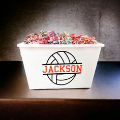 a white bucket filled with colorful sprinkles on top of a table