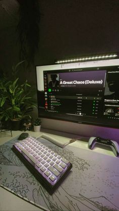 a keyboard and mouse on a desk in front of a computer monitor with the screen lit up