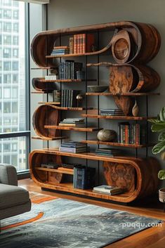 a living room filled with furniture and a book shelf next to a large window on top of a hard wood floor