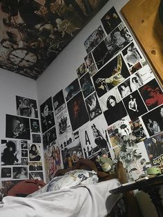 a bedroom with many pictures on the wall