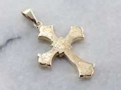 This stunning antique cross is hollow, providing a substantial impact with a minimum of weight. This dates to the late 1890's or early 1900's. Crafted of 14k gold, this warm yellow gold cross is sophisticated and just a little gothic!This pendant does not come with the chain shown. Please feel free to contact us, we will help you find the perfect chain for your style and budget!Metal: 14K Yellow GoldMeasures: 41 L x 25 W x 3.5 H mm SKU #: PUHTA3-NEach piece has been identified and graded by a Gr Antique Yellow Gold Crucifix Jewelry, Antique Yellow Gold Cross Pendant Jewelry, Leaf Motif, Warm Yellow, Gold Cross, Eternity Bands, Cross Pendant, Large Size, Dates