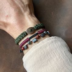 I'm excited to introduce a brand new Unisex Boho Bracelet Set! With its colors and details, this 3-piece bracelet set boasts a bohemian yet classy style that both women and men will love to wear. I have combined my favorite harmony of khaki and burgundy colors with a brown button piece (copper), Bloodstone, and Hematite stones to create a delightful set. Each piece is designed with an adjustable size, so there will be no size issues. For very thick wrists, just send me a DM immediately after you Stack Bracelet, Clothing Guide, Hematite Stone, Classy Style, Boho Bracelet, Ethnic Jewelry, Boho Bracelets, Burgundy Color, Bracelet Stack