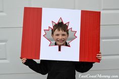 a boy holding up a canadian flag photo booth sign with the text dollar store canada 150 photo booth