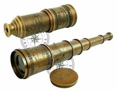 two brass telescopes on top of each other with compass symbols in the middle one