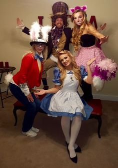 four people dressed in costumes posing for a photo