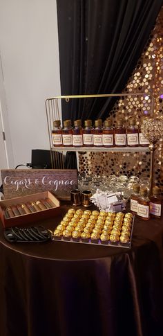 a table topped with lots of different types of cookies and confection bottles on top of it