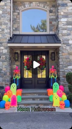 the front entrance to a house decorated for halloween with balloons and decorations on display in front