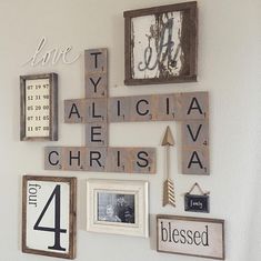 a wall filled with lots of different types of scrabble tiles and framed pictures