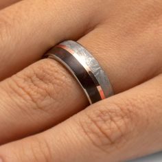 a woman's hand with a wedding ring on it