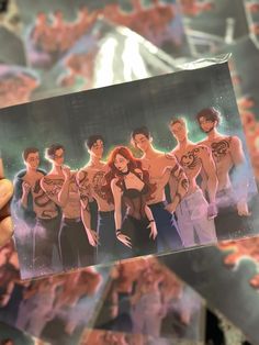 a person holding up a card with an image of the cast of riverdale high school musical