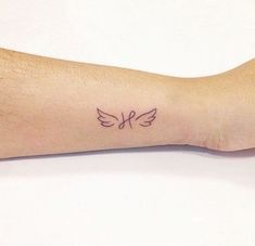 a person's arm with a small tattoo on the left side of their arm