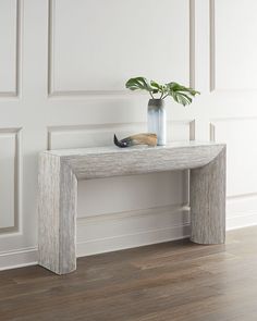 a white table with a plant on it