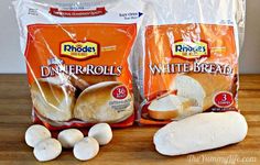 two bags of white bread sitting on top of a wooden table