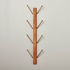 a wooden wall mounted coat rack with hooks