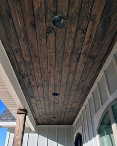 the front porch is covered with wood planks