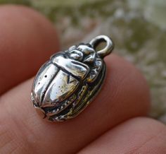 The Ancient Egyptian scarab is a symbol of rebirth and resurrection...as well as good luck and fortune charm!  These are solid sterling silver and weigh nearly 7 grams each. -Size 15.5mm x 10mm (measure does not include loop) -These are thick!  6.5mm thick -Overall length including the loop is 19.5mm -Sterling Silver -Authentic reproduction of a Vintage Scarab from Egypt -Option to have us attach a jump ring for you:  Standard round 16g with 5mm ID  Shop with confidence! We offer a money back guarantee on all of our artisan pieces. If you aren't happy for any reason, just return within 14 days. Please note that ALL of our sterling silver is .925 which is 92.5% silver and 7.5% copper. Scarab Amulet, North Compass, Egyptian Scarab, Amulet Charm, Ormond Beach, Silver Buttons, The Loop, Ancient Egyptian, 14kt Gold