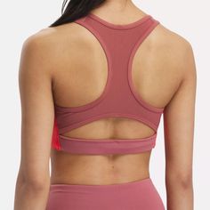 This Reebok sports bra offers medium support for spin class or personal training sessions. It has a pullover design, with removable pads for shaping and coverage. Angled side seams give you stability and support. When it's time to up the intensity, Speedwick tech helps wick sweat away from your skin. Supportive Pink Activewear With Built-in Padding, Pink Functional Activewear With Built-in Padding, Pink Functional Sports Bra With Built-in Padding, Pink Supportive Activewear With Built-in Padding, Pink Activewear With Built-in Padding For Light Sports, Nylon Color Block Activewear Athleisure, Nylon Color Block Activewear For Workout, Pink Nylon Sports Bra For Light Exercise, Pink Nylon Activewear With Medium Support